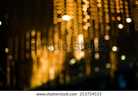 stock photo blur light from Chandeliers in low light place colorful with orange blue green and black shade