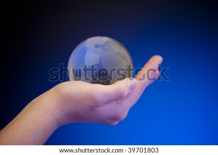 Fragile glass Earth in palm of hand