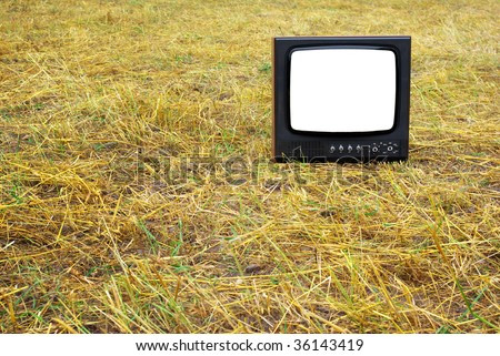 Old television set stand on hay. Conceptual design.