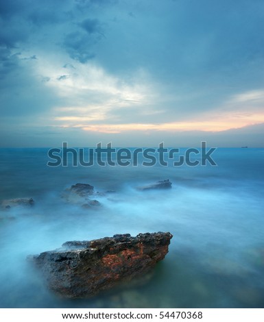 Rocks and sea storm. Dramatic scene. Composition of nature