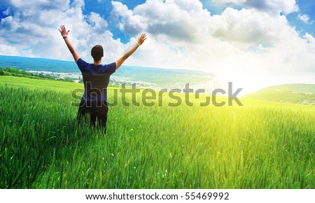Man in meadow green meadow. Emotional scene. - stock photo