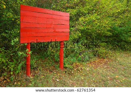 Red notice board in forest. Element of design.