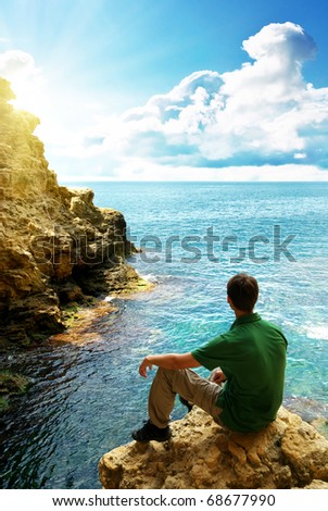 Man in sea cave. Composition of nature.
