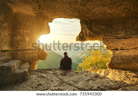 Man in cave mountain. Conceptual scene.