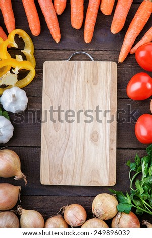 Cutting board with vegetables mix on the table