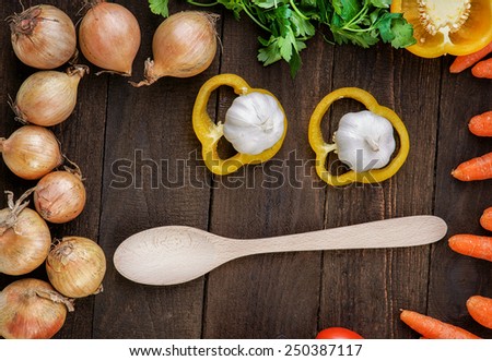 Wooden spoon with vegetables mix on the table