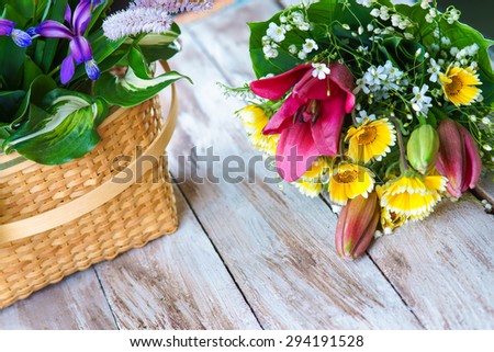 Various flowers on the table and flowers basket