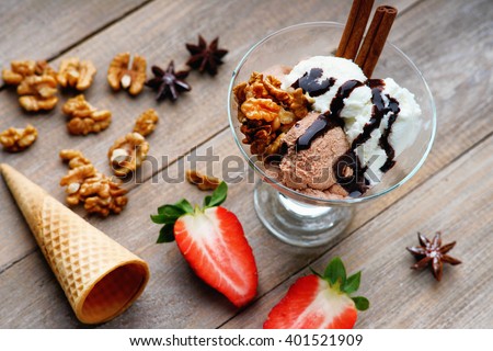 Ice cream sundae, waffle cone and sliced strawberry