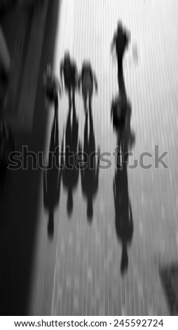 Blurred image abstract human shadow walk in the city. black and white design for background.
