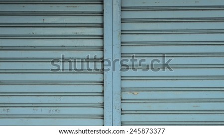 Close up blue metal roller door shutter background and texture
