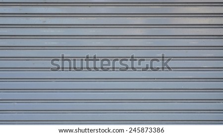 Close up gray metal roller door shutter background and texture