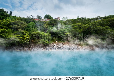 Blue hot spring pond in forest