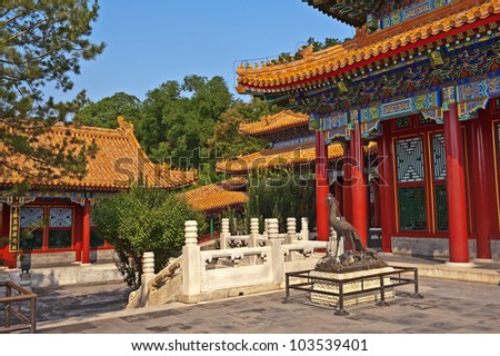 The vibrant ornate pavilions of the historic Summer Palace in Beijing overlooking quiet shaded patio and marble bridges. on Longevity Hill