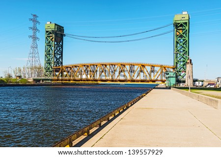 The Burlington Canal Lift Bridge is located on the western shore of Lake Ontario. The bridge spans the Burlington Canal that was opened in 1826.