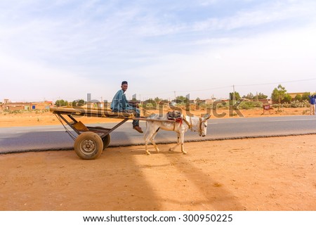 Khartoum, Sudan - January 29, 2015: Man on the cart is carrieb by donkey in Khartoum in Sudan.