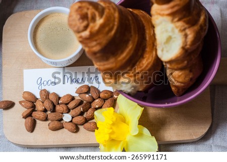 Breakfast with croissants almonds and good morning note