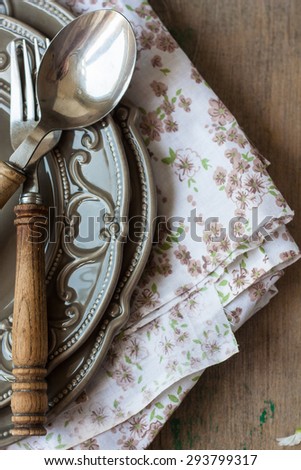 Table setting with napkin and cutlery on a wooden table