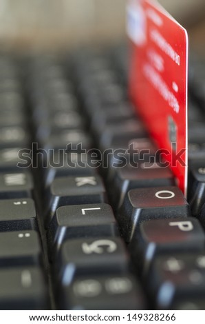 A credit card wedged into the keys of a keyboard