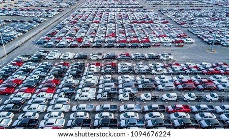 Aerial top view new car lined up in the port for import and export, New car business logistic and transportation to dealership.