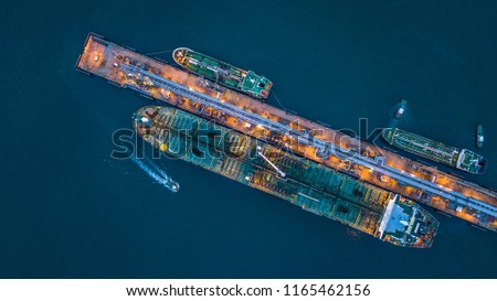 Aerial top view oil tanker ship loading in port view from above, Tanker ship logistic import export business and transportation.