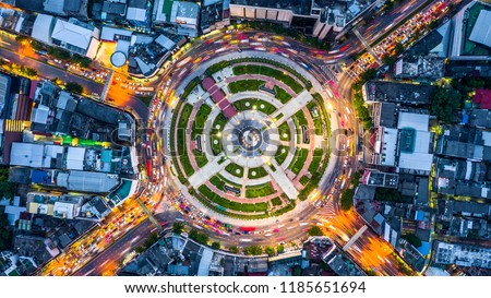 Aerial top view road roundabout with car lots,   Aerial view road traffic in city at night.