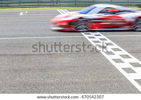 Race car crossing the finish line on a circuit