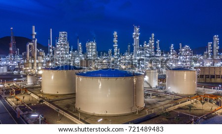 Oil storage tank with oil refinery background, Oil refinery plant at night.