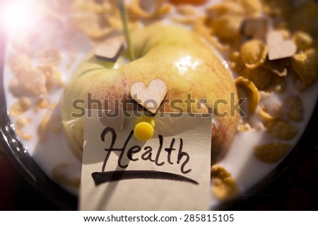 Healthy muesli and organic foods. An apple with cereal and milk with a note \