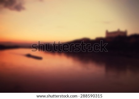 Blurred vintage background of sunset on the Danube River with Bratislava Castle View in Bratislava, Slovakia