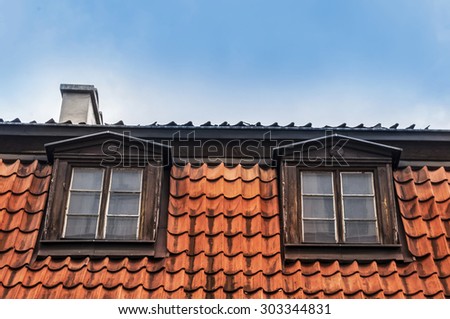 Two windows on a red roof