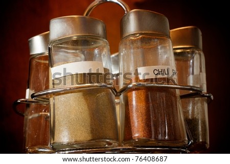 Close up of a spice rack with multiple spices labeled, with one blank label