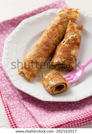 Crepes with honey, sugar and cinnamon. Selective focus.