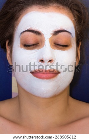 Beautiful Woman With Cosmetic Mask on Face at home.