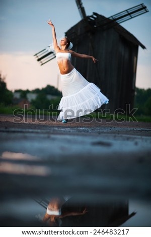 Creative portrait of artistic bride dancing outdoors