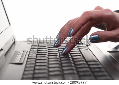 female hands typing on laptop keyboard on white