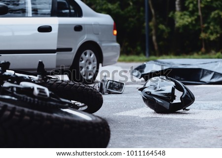 Motorcycle helmet on the street after a fatal accident with a car