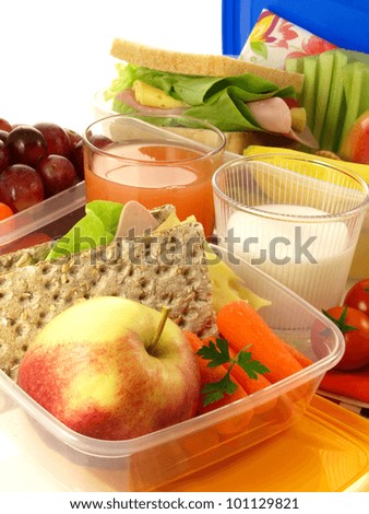 Box with lunch, milk and fresh grapefruit juice