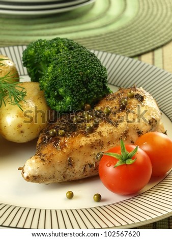 Roasted chicken breast, tomatoes, potatoes and broccoli