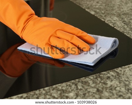 Hand in glove cleaning kitchen cooking top