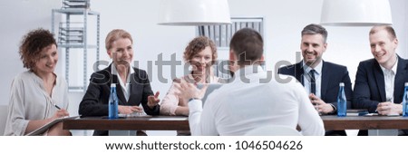 Group of smiling recruiters listening to a man with good references