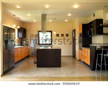 Person movement in stylish new kitchen