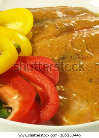 Closeup of salmon in curry sauce and paprika