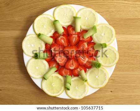 Strawberries, lemon and avocado in composition, bird eye view