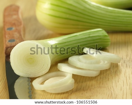 Cutting a small onion bulb on the cutting board