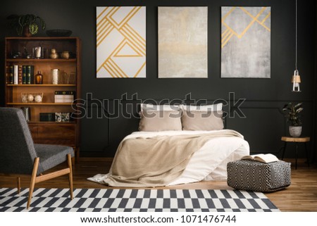 Modern wooden bedroom interior with white bed, carpet, bookcase and armchair
