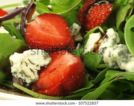 Strawberry pieces in cheese and spinach salad