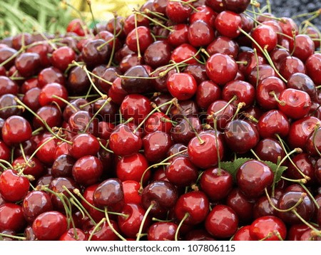 Heap of cherries for sale on stall table