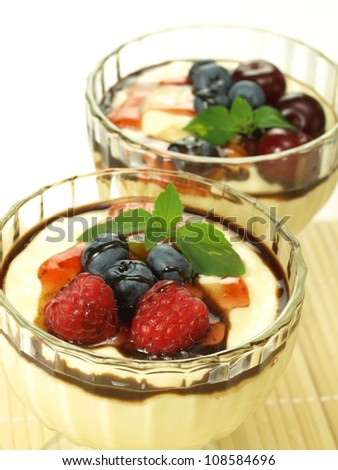 Vanilla puddings with ripe summer fruits, closeup