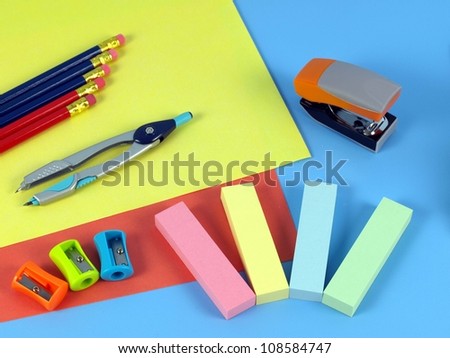 Colorful office\'s accessories on blue desk
