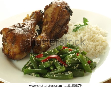 Closeup of chinese dinner: chicken legs and vegetables